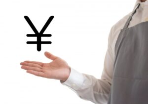 店舗清掃の料金を教える人の手