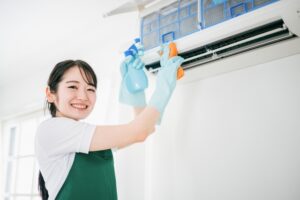 エアコン内部を洗浄する清掃スタッフ