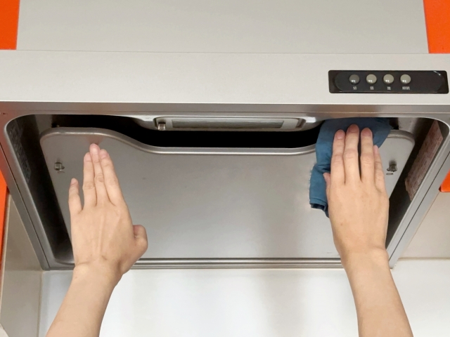 外せない換気扇を掃除する人の手